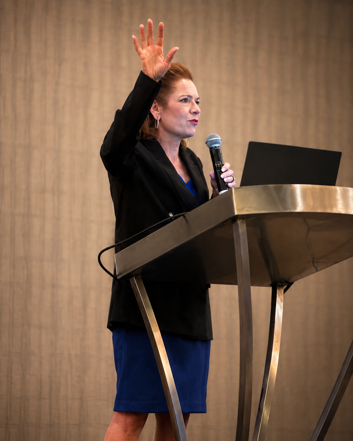 Dr. Gina Pritchard speaking at a conference podium